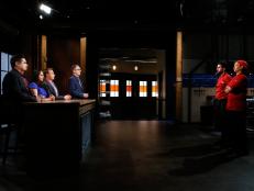 From left, judges Aaron Sanchez, Maneet Chauhan and Marc Murphy and host Ted Allen face chefs Meny Vaknin and Elderoy Arendse following the dessert round, as seen on Food Network's Chopped, Season 28.
