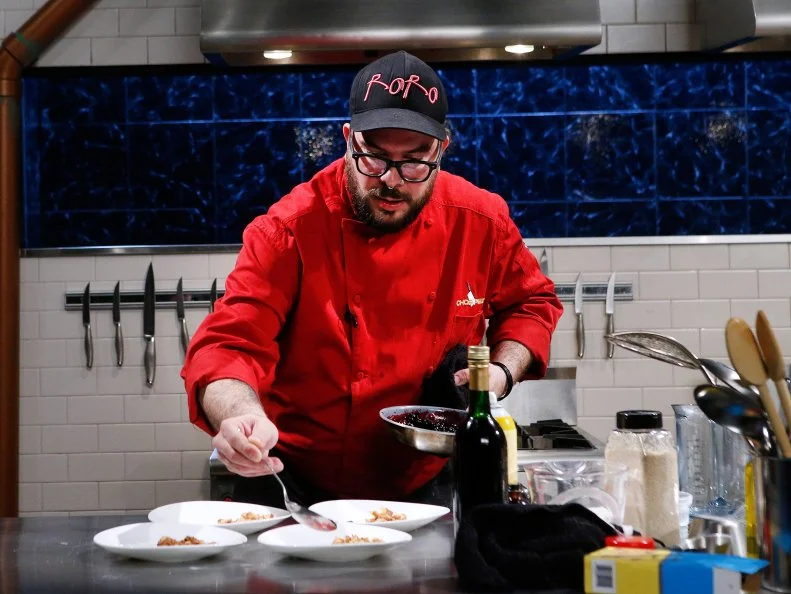 Chef Rian "RoRo" Morales cooks with bison jerkey, sour cream, freeze dried blueberries and an egg waffle during the dessert round, as seen on Food Network's Chopped, Season 28.