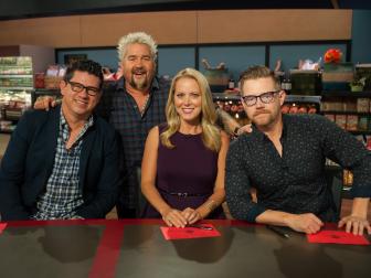 Host Guy Fieri with judges Troy Johnson, Melissa D'Arabian and Richard Blais posed, as seen on Food Network's Guy's Grocery Games, Season 9.
