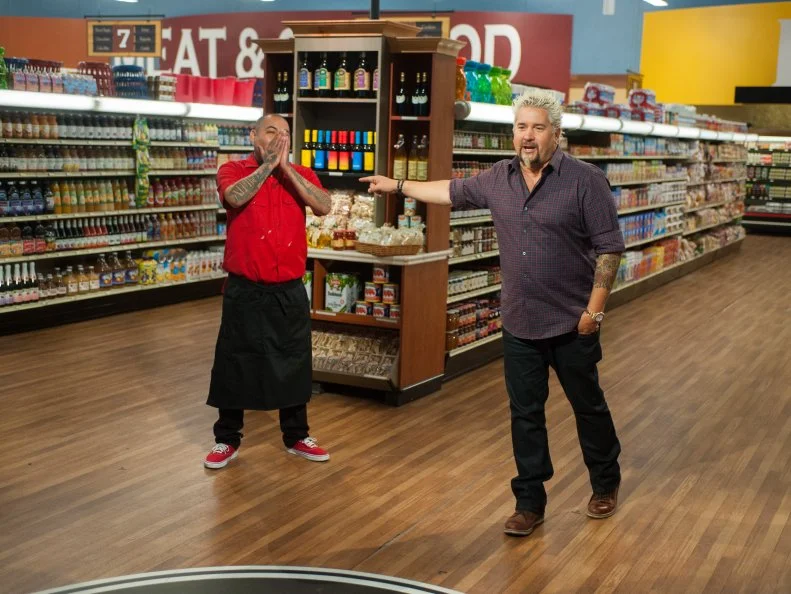 Host Guy Fieri congradulates contestant Chris Tzorin as the winner of Guys Grocery Games, as seen on Food Network's Guy's Grocery Games, Season 9.