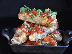 This French Quarter gem with a Caribbean vibe serves punch and tropical snacks (think peas and rice cooked with plenty of andouille). The Caribbean flavors really shine through in dishes like the Crispy Rum Ribs. Duroc pork ribs are seasoned and grilled, then braised in Guyanese rum punched up with poblano peppers. A quick dip in the fryer adds a &ldquo;crazy, crazy crunchy crust&rdquo; to the ribs, Michael Symon says.
