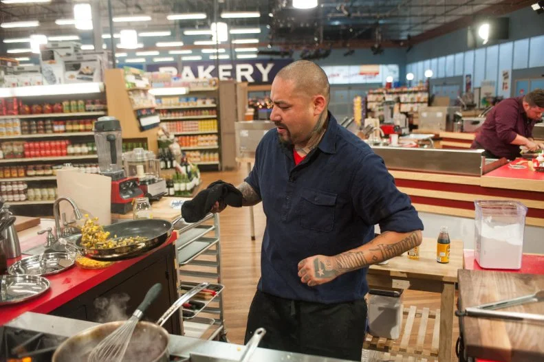 Contestant Chris Tzorin prepares his dish, as seen on Food Network's Guy's Grocery Games, Season 9.