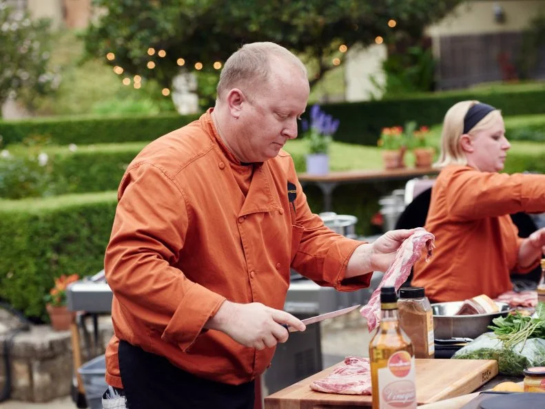 Chefs Christopher Schobel and Karen Mitchell preparing their dishes for Round 1, as seen on Food Network's Chopped, Grill Masters Special.