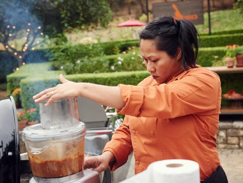 Chef Sophina Uong preparing her Round 1 dish, Grilled Lamb Belly Salad on a Grilled Grapefruit & Baked Bean Puree with Feta, as seen on Food Network's Chopped, Grill Masters Special.