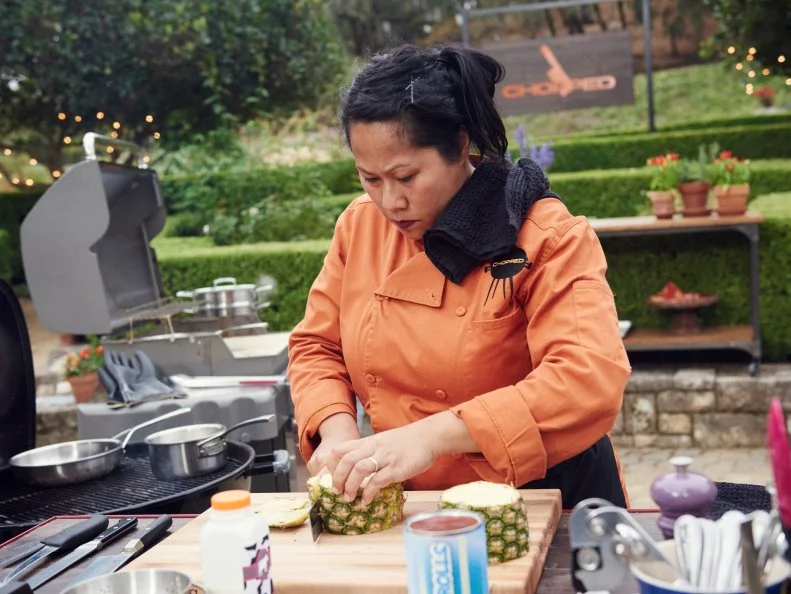 Chef Sophina Uong preparing her dish for Round 3, Grilled Caramel Cinnamon Bun with Smoked Strawberry & Pineapple Salsa with Tamarind Cream & Mascarpone, as seen on Food Network's Chopped, Grill Masters Special.
