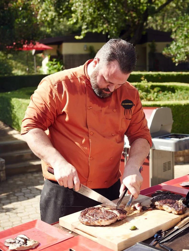 Chef Jason Bergeron preparing his dish for Round 2, Cowboy Steak with Babaganoush, Grilled Portobello, and Grilled Onion, as seen on Food Network's Chopped, Grill Masters Special.