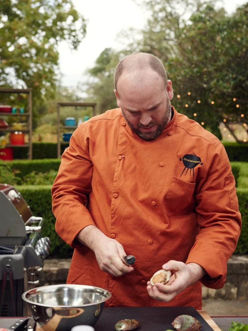 Chef Daniel Gomez Sanchez preparing his dish for Round 1, Grilled Abalone with Swiss Chard, Raisins, & Red Curry Broth, as seen on Food Network's Chopped, Grill Masters Special.