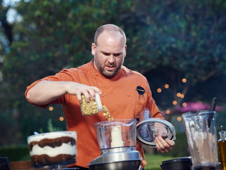 Chef Daniel Gomez Sanchez preparing his dish for Round 3, Grilled Pear with Grilled Bacon and Pistachio Caramel and Mousse of Trifle, as seen on Food Network's Chopped, Grill Masters Special.