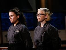 Shawna DeLima, right, reacts with fellow teen chef Eliana de Las Casas as she is chopped during the dessert round chopping, as seen on Food Network's Chopped, Season 29.