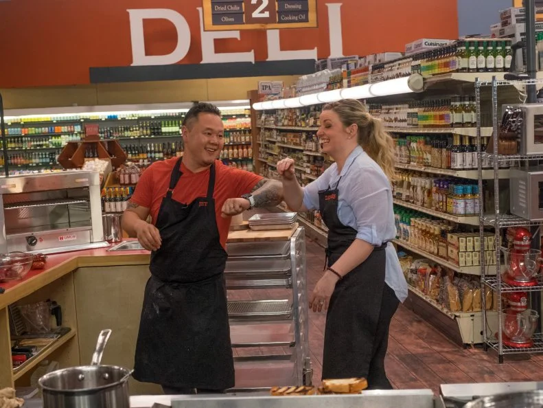 Contestant Jet Tila and Damaris Philips laughing, as seen on Food Network's Guy's Grocery Games, Season 10.