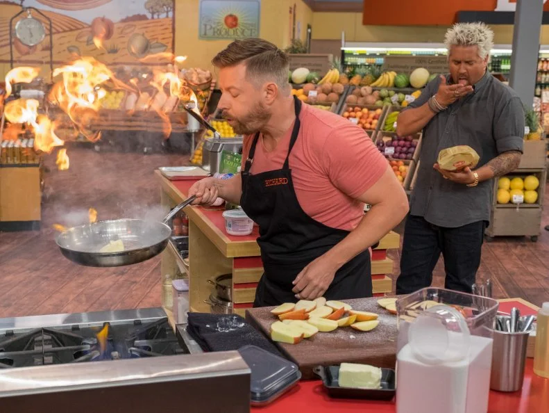 Contestant Richard Blais sets fire to cut up apples, as seen on Food Network's Guy's Grocery Games, Season 10.