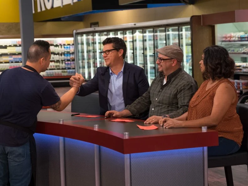 Contestant Jet Tila says goodbye to judges Troy Johnson, Carl Ruiz and Aarti Sequeira, as seen on Food Network's Guy's Grocery Games, Season 10.