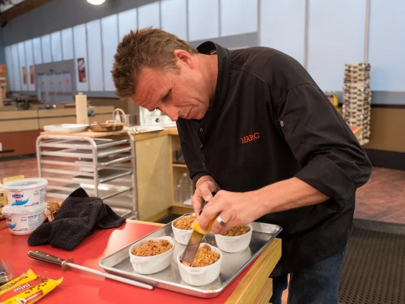 Contestant Marc Murphy adds lemon zest to his apple crumble, as seen on Food Network's Guy's Grocery Games, Season 10.