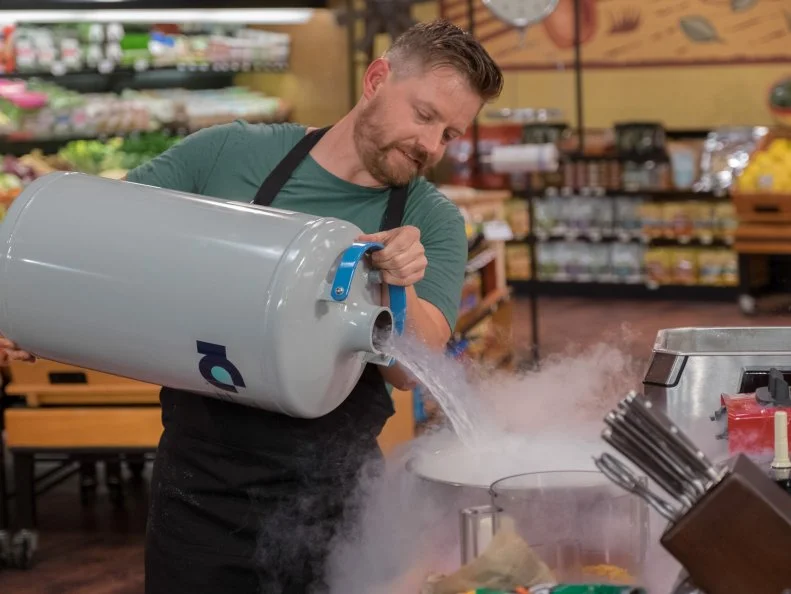 Contestant Richard Blais pours liquid nitrogen into a bowl, as seen on Food Network's Guy's Grocery Games, Season 10.