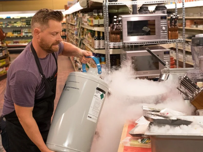 Contestant Richard Blais pours liquid nitrogen into a bowl, as seen on Food Network's Guy's Grocery Games, Season 10.