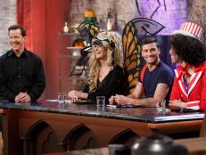 Judges, from left, Sandra Lee, Damiano Carrara, and Carla Hall critique a chocolate buttermilk cake made to resemble a brain prepared by Veronica von Borstel (off camera), during the judging of the main-heat challenge as seen on Food Network's Halloween Baking Championship, Season 2.