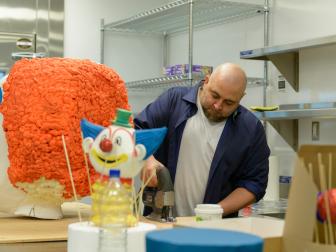 Food network's Duff Goldman cuts plywood for his his clown cake in the kitchen at the Linq Hotel and Casino, as seen during the 2016 All Star Halloween Spectacular. (action)