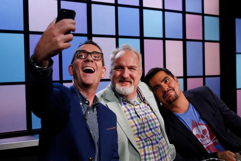 Host Ted Allen takes a selfie with judges Art Smith, center, and Aaron Sanchez, as seen on Food Network's Chopped Junior, Season 1.