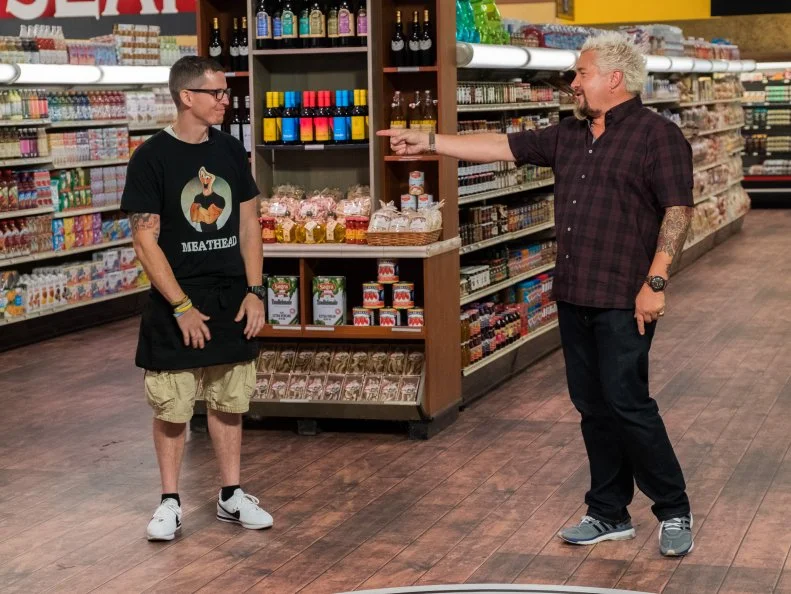 Host Guy Fieri points at contestant Bobby Marcotte, as seen on Food Network's Guy's Grocery Games, Season 12.