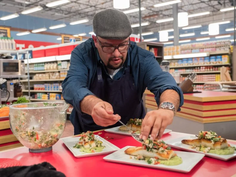 Champion Carl Ruiz plates his dish, as seen on Food Network's Guy's Grocery Games, Season 12.