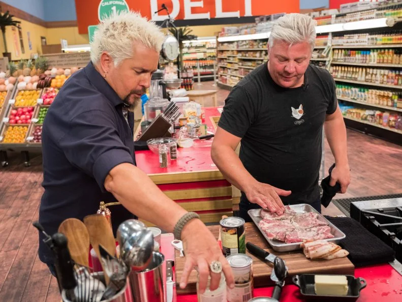 Host Guy Fieri discusses with Contestant Adam Sappington, as seen on Food Network's Guy's Grocery Games, Season 12.
