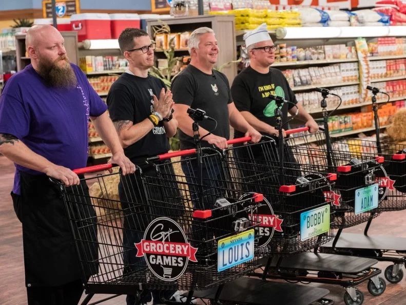 Contestants Louis Remillard, Bobby Marcotte, Adam Sappington, and Zane Caplansky wait for the NYC Frozen Food Feud to begin, as seen on Food Network's Guy's Grocery Games, Season 12.