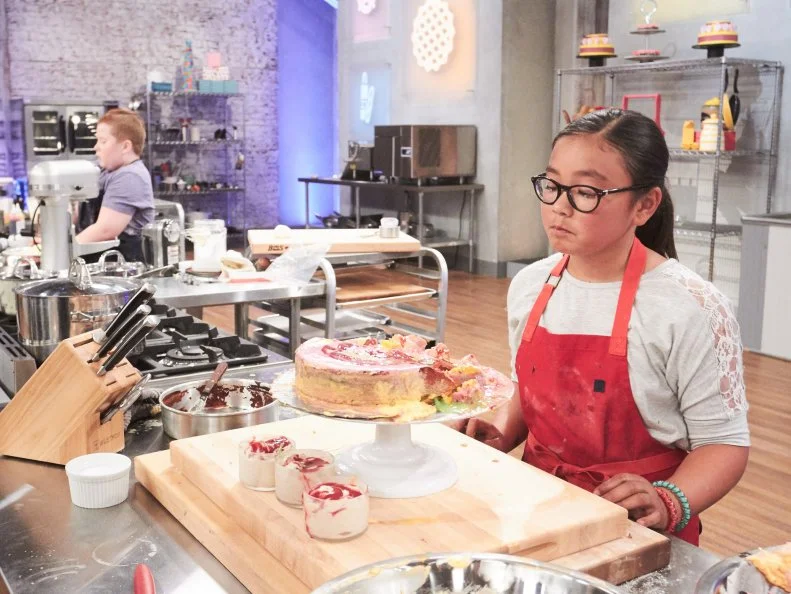 Contestant Keili Gorczyca preparing her Main Heat dish, Cinnamon Apple Tie Dye Cake with Orange Zest Buttercream and Raspberry Coulis and Triple Cinnamon Ice Cream with a Raspberry Coulis Drizzle, as seen on Food Network's Kids Baking Championship, Season 3.