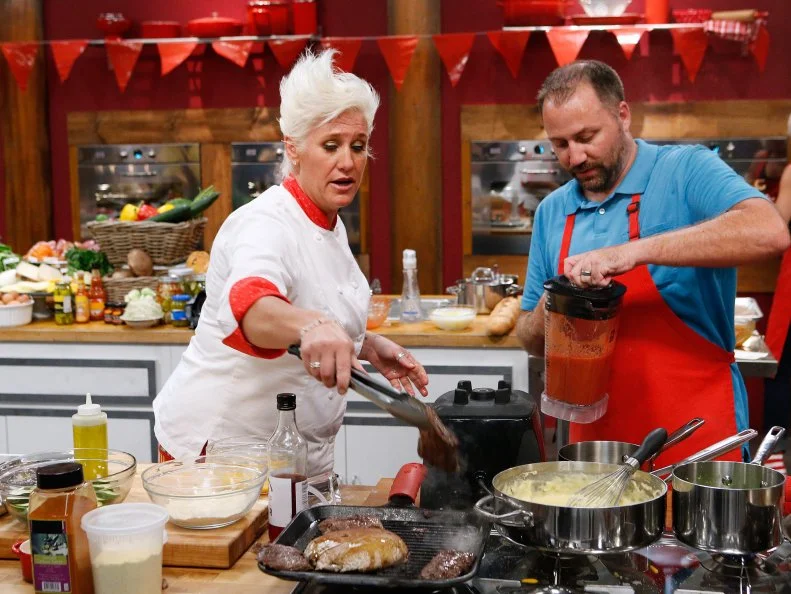 Mentor Anne Burrell checks in on Jeff West of the red team as he cooks during the main dish challenge, as seen on Food Network's Worst Cooks in America, Season 10.