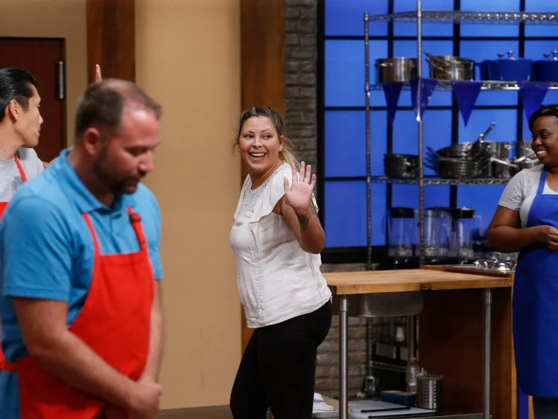 Kayla Kurtz of the red team waves as she leaves the kitchen after being eliminated, as seen on Food Network's Worst Cooks in America, Season 10.