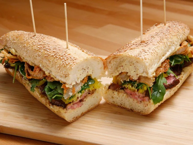 Mentor Anne Burrell's Steak Sandwich with Mustard Cheese Sauce dish is displayed, as seen on Food Network's Worst Cooks in America, Season 10.