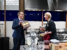 Host Ted Allen (L) gives judge Amanda Freitag a special chocolate bar for Amanda Freitag during the dessert round, Chocolate, as seen on Food Network's Chopped After Hours, Season 32.