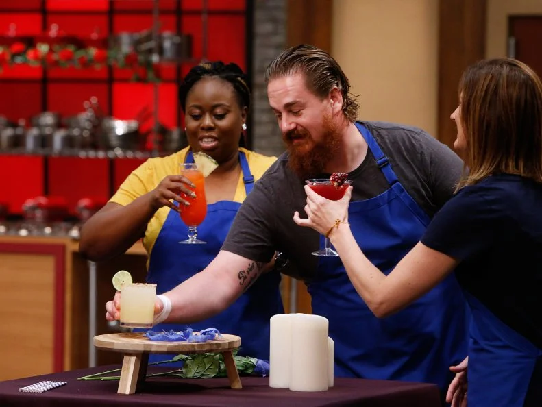 Ann Odogwu, Adam Cooke and Laura Docker of the blue team sample cocktails before the opening game, as seen on Food Network's Worst Cooks in America, Season 10.