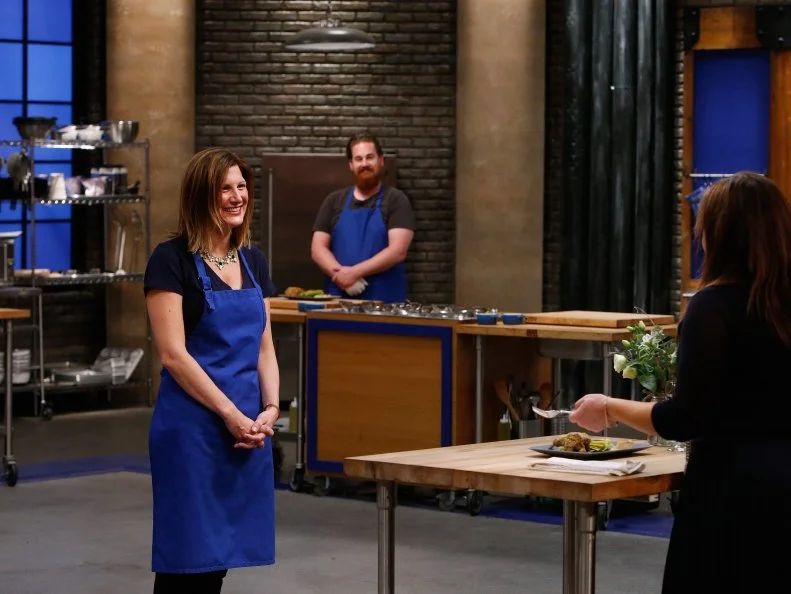 Mentor Rachael Ray tastes Laura Docker's dish during the blue team's main challenge tasting, as seen on Food Network's Worst Cooks in America, Season 10.