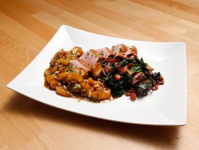 Mentor Anne Burrell's Seared Duck Breast with Peach Chutney and Rainbow Chard with Bacon dish is displayed, as seen on Food Network's Worst Cooks in America, Season 10.