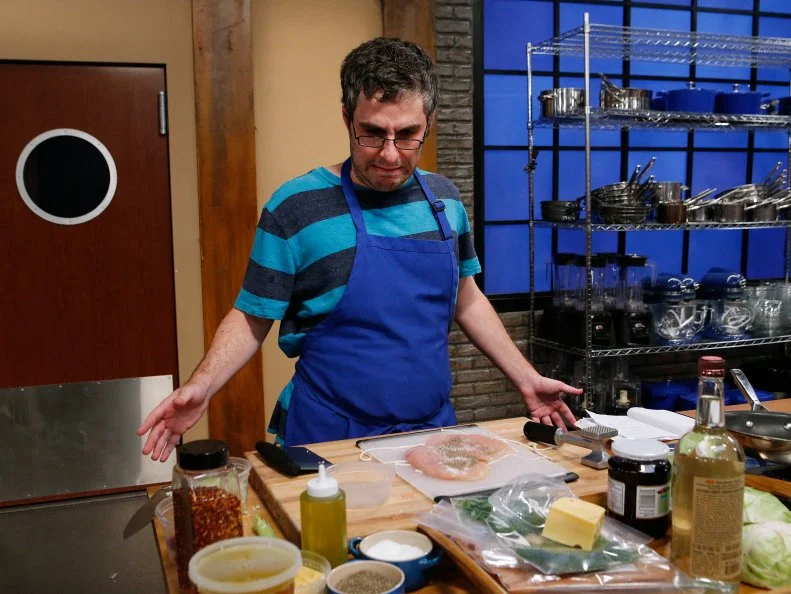 Matt Josephs of the blue team cooks during the main dish challenge, as seen on Food Network's Worst Cooks in America, Season 10.