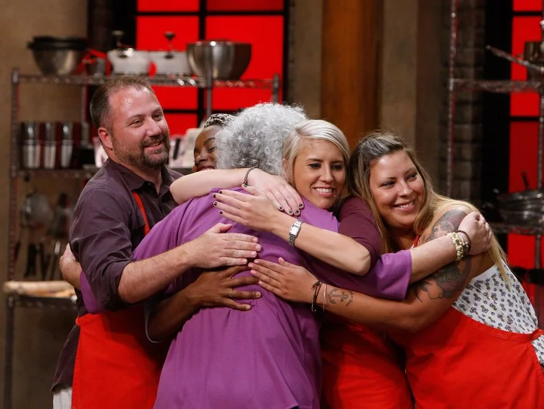Jetta Ostrofsky hugs her teammates after being eliminated from the red team, as seen on Food Network's Worst Cooks in America, Season 10.