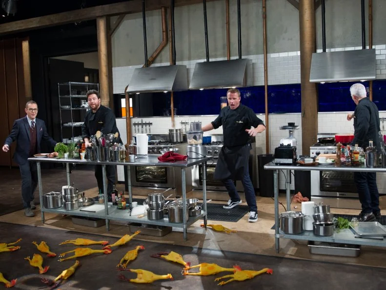 Host Ted Allen (L) and Judges Scott Conant, Marc Murphy, and Geoffrey Zakarian react when rubber chickens appear on set during the entrŽe round, Whiskey & Wings, as seen on Food Network's Chopped After Hours, Season 32.