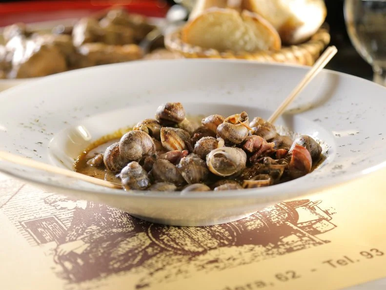 Snails in Hot Sauce as served at Cal Boter in Barcelona, Spain as seen on Food Network's Diners, Drive-Ins and Dives episode 2601.
