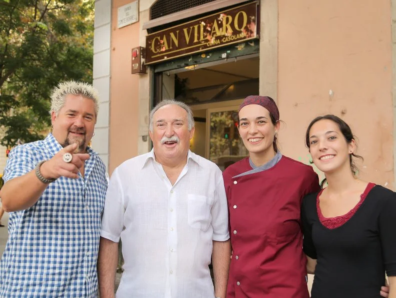 Host Guy Fieri with Owner Cisco Vilaro, Chef Anna Maria, and sister Alba Vilaro outisde Can Vilaro in Barcelona, Spain as seen on Food Network's Diners, Drive-Ins and Dives episode 2602.
