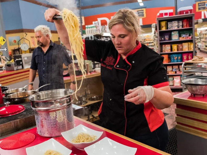 Contetant Heather Ludzack uses to scoop up bucatini noodles, as seen on Food Network's Guy's Grocery Games, Season 12.