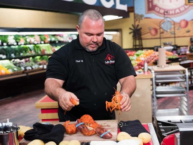 Contestant Michell Sanchez prepares lobster, as seen on Food Network's Guy's Grocery Games, Season 12.