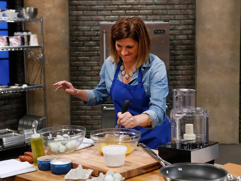 Laura Docker of the blue team cooks during the skill drill challenge, as seen on Food Network's Worst Cooks in America, Season 10.