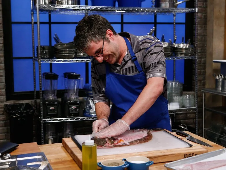 Matt Josephs of the blue team cooks during the main dish challenge, as seen on Food Network's Worst Cooks in America, Season 10.