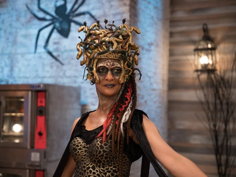 Judge Carla Hall in her medusa costume for the main heat, as seen on Food Network's Halloween Baking Championship Season 3