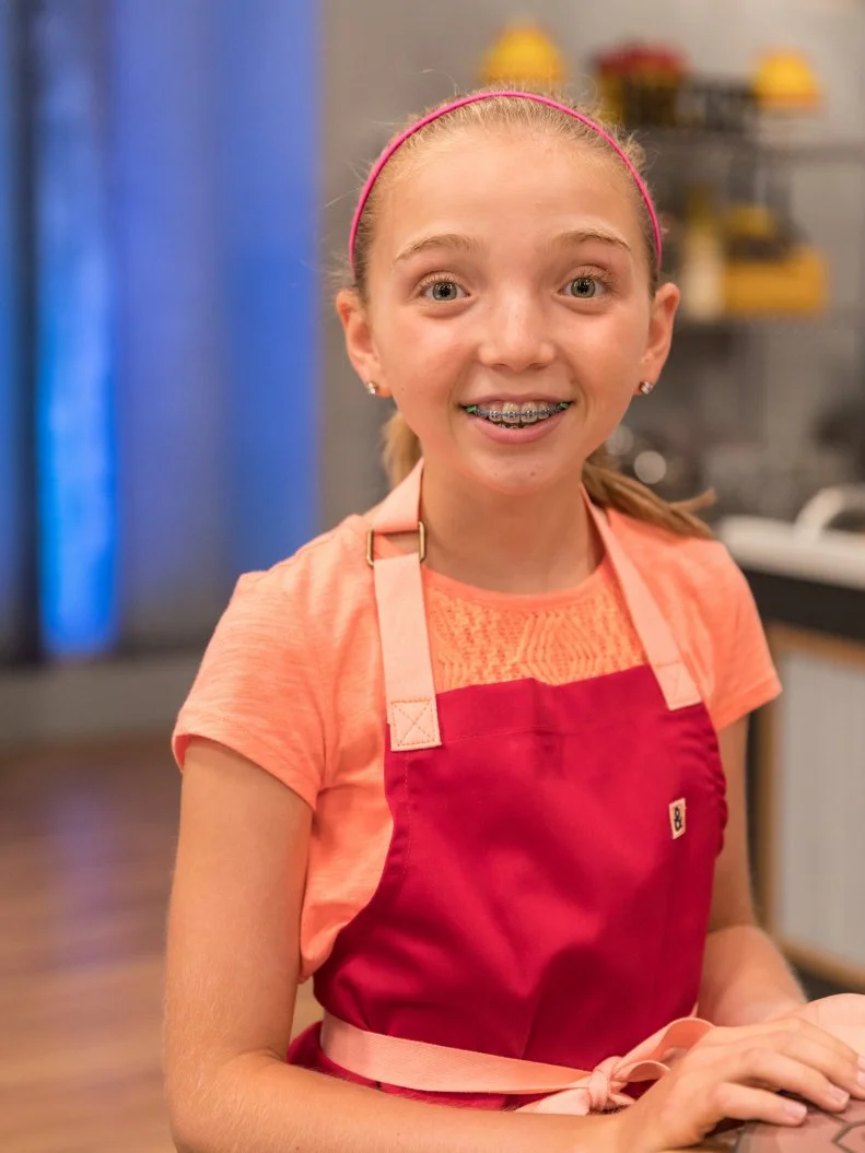 Contestant Abby Martin poses for a photo in the main heat, as seen on Food Network's Kids Baking Championship Season 4