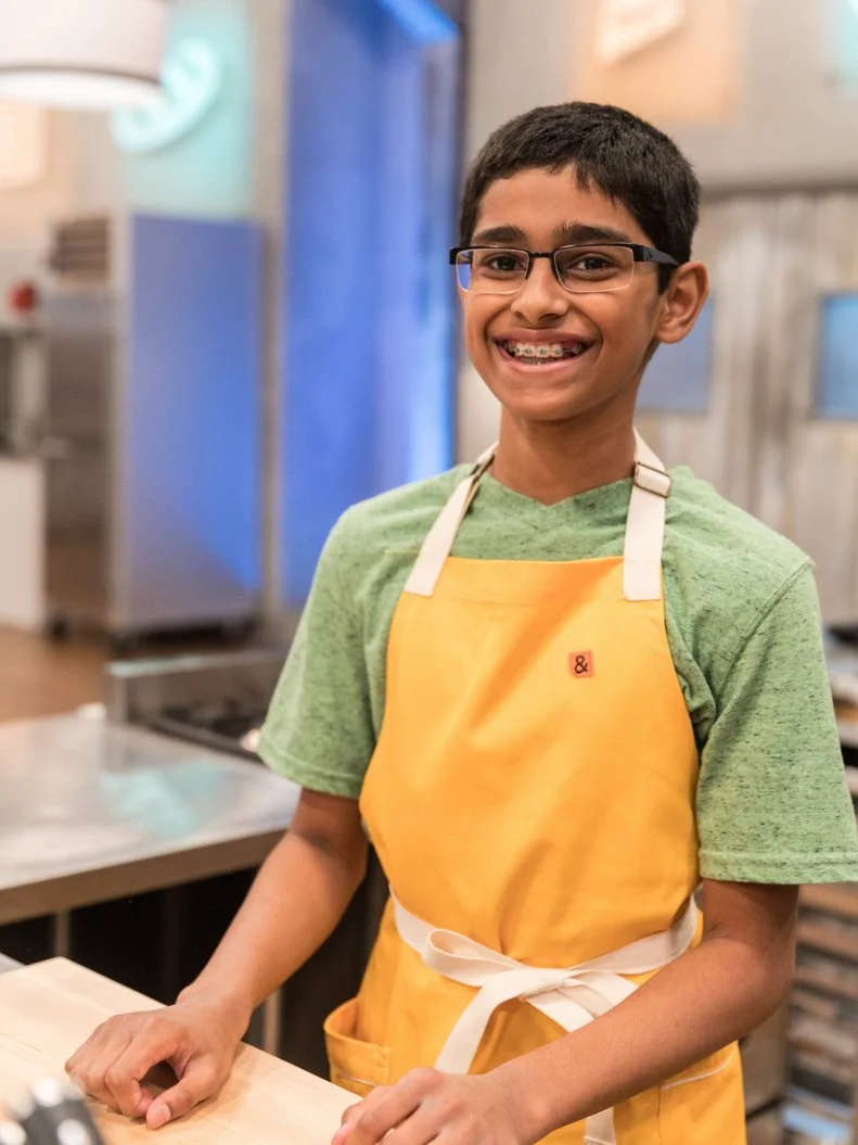 Contestant Aditya Pillutla poses for a photo in the main heat, as seen on Food Network's Kids Baking Championship Season 4