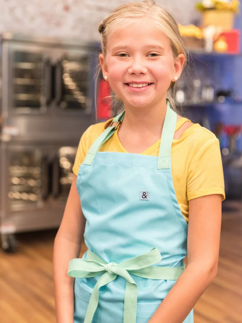 Contestant Bryn Montgomery poses for a photo in the main heat, as seen on Food Network's Kids Baking Championship Season 4