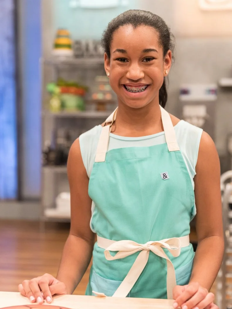 Contestant Soleil Thomas poses for a photo in the main heat, as seen on Food Network's Kids Baking Championship Season 4