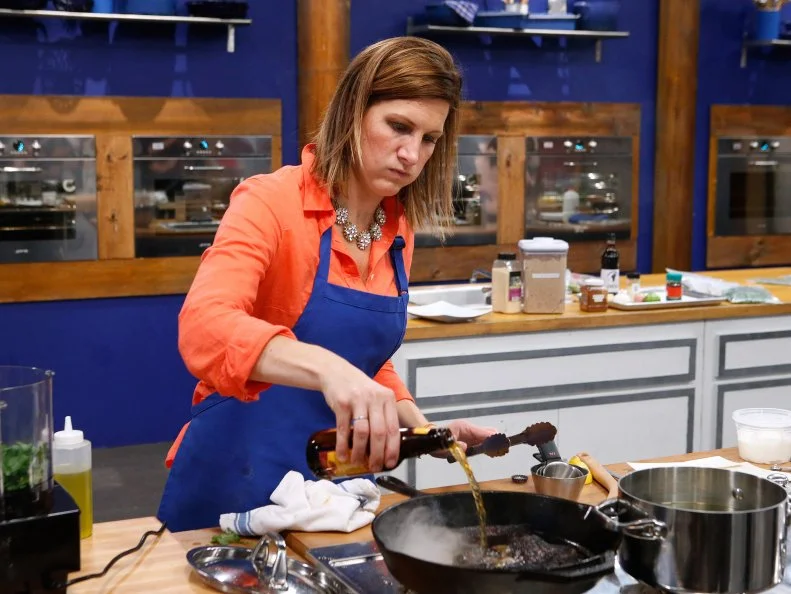 Laura Docker of the blue team cooks during the main dish challenge, as seen on Food Network's Worst Cooks in America, Season 10.