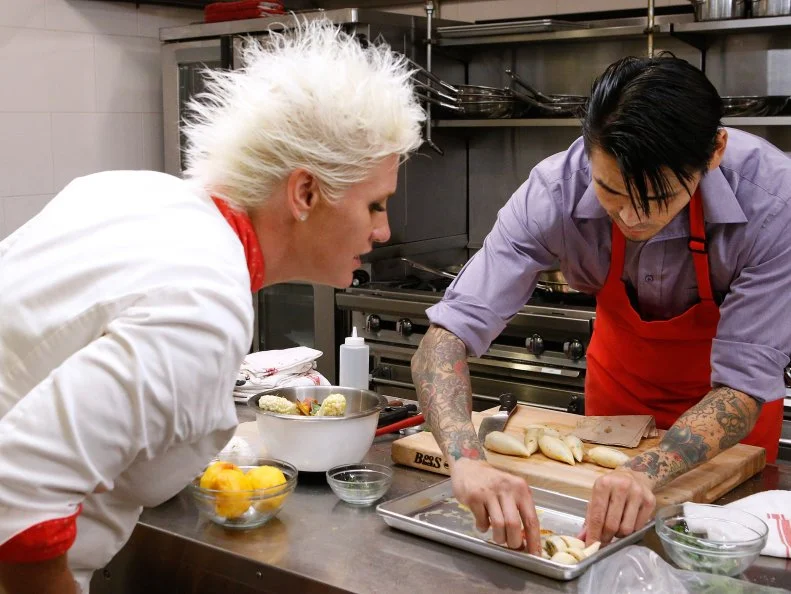 Mentor Anne Burrell works with red team finalist Daniel Mar as he cooks during the finale, as seen on Food Network's Worst Cooks in America, Season 10.